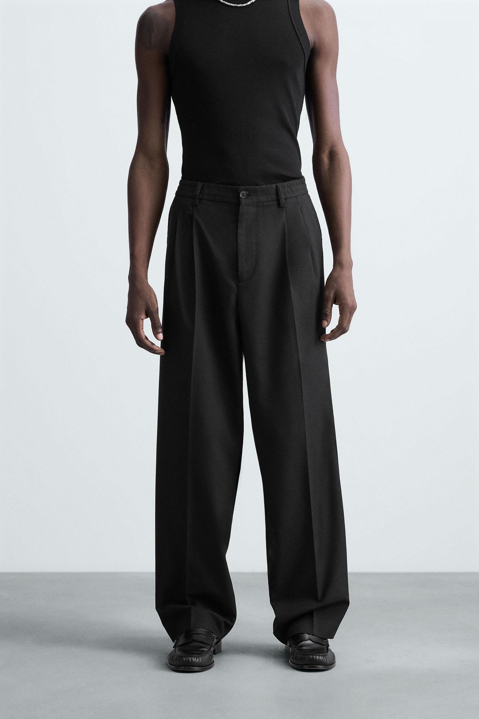 FLOWY PLEATED WIDE FIT PANTS Product Image