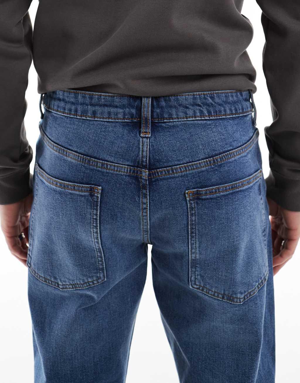 ASOS DESIGN stretch tapered jeans in mid wash Product Image