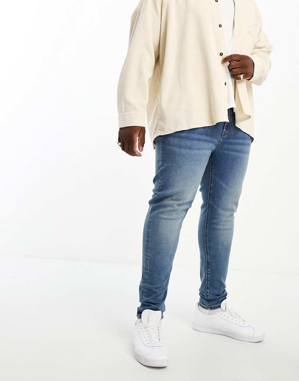 ASOS DESIGN power stretch jeans in mid wash blue Product Image