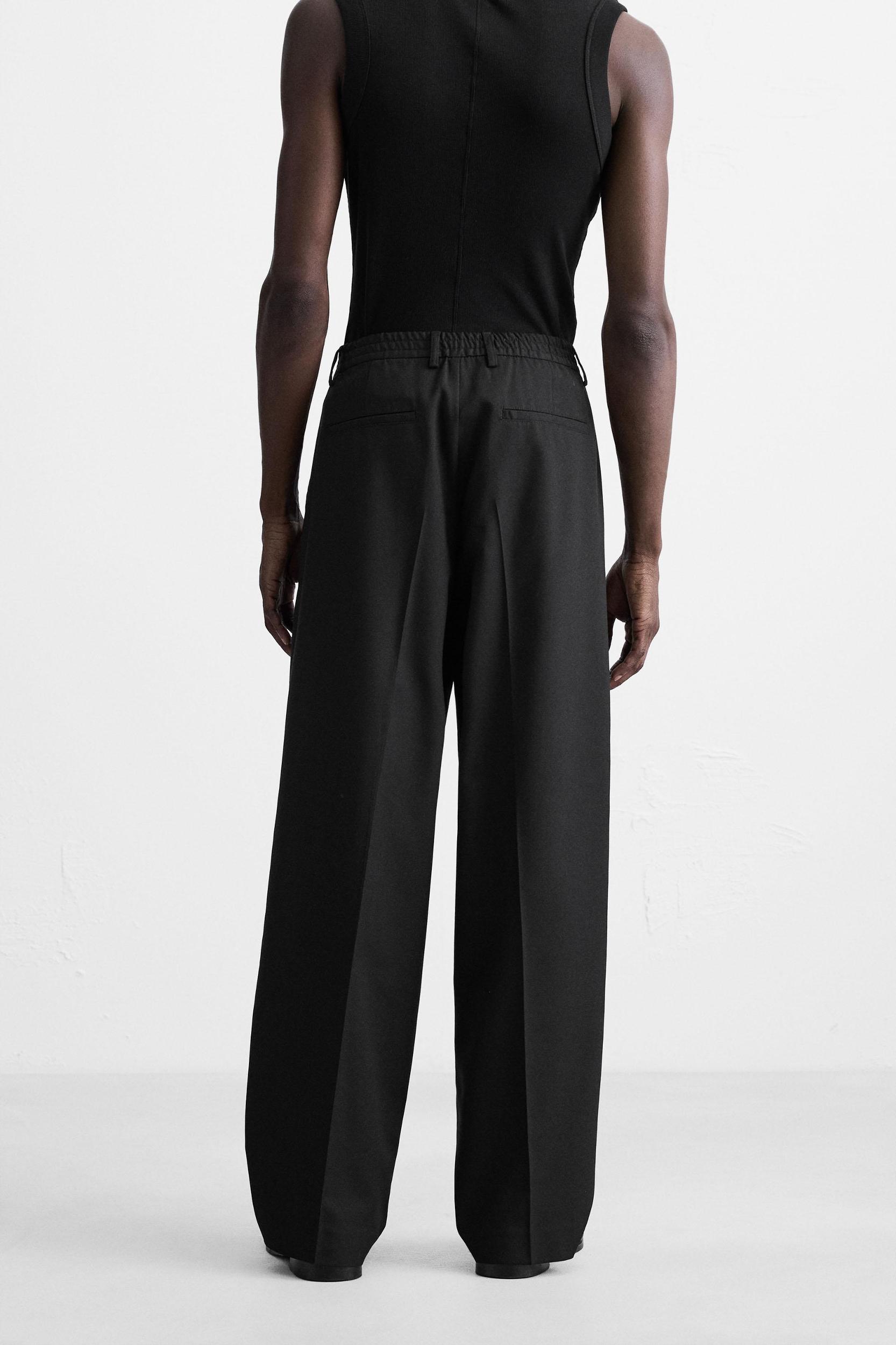 FLOWY PLEATED WIDE FIT PANTS Product Image