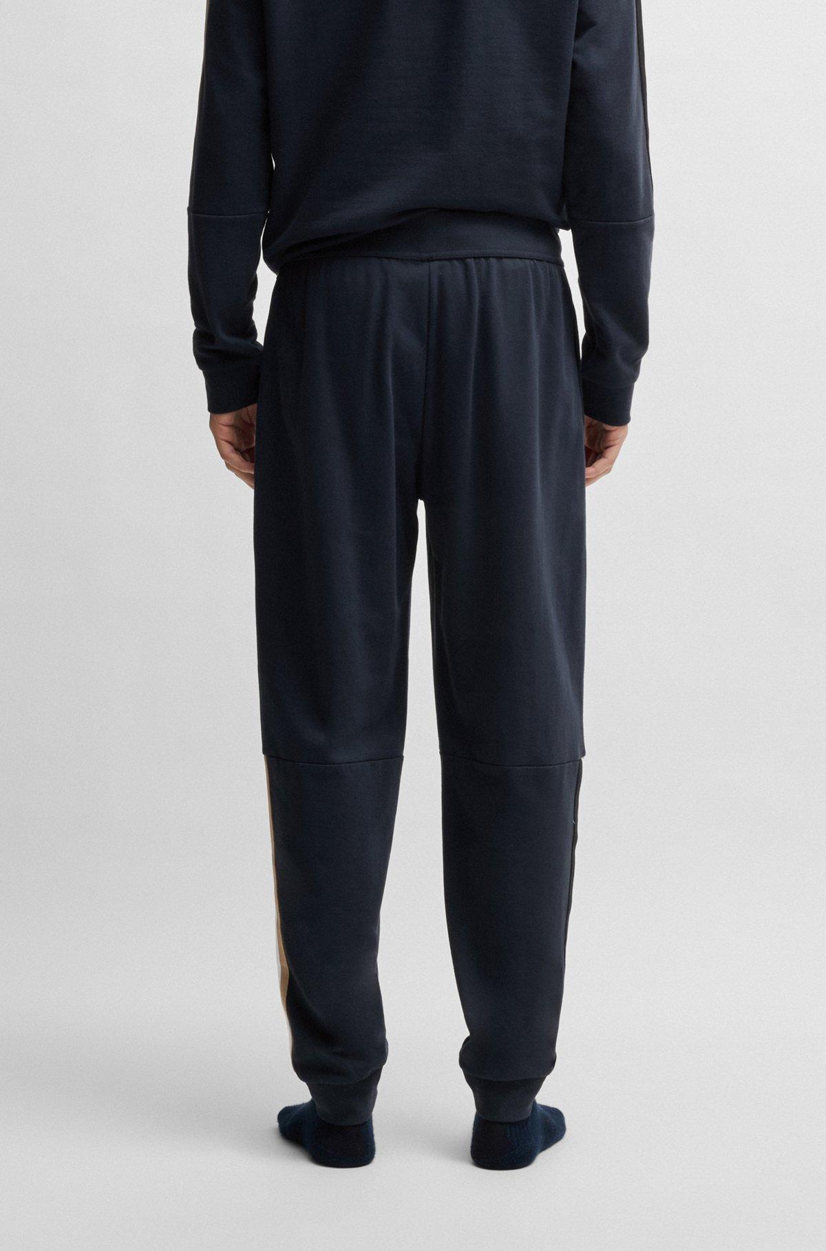 Cotton-terry tracksuit bottoms with tape inserts Product Image
