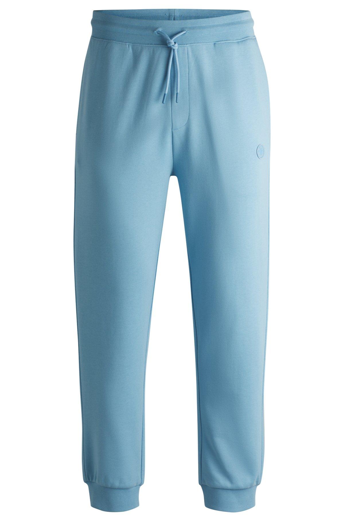 Cotton-terry tracksuit bottoms with Happy HUGO logo Product Image
