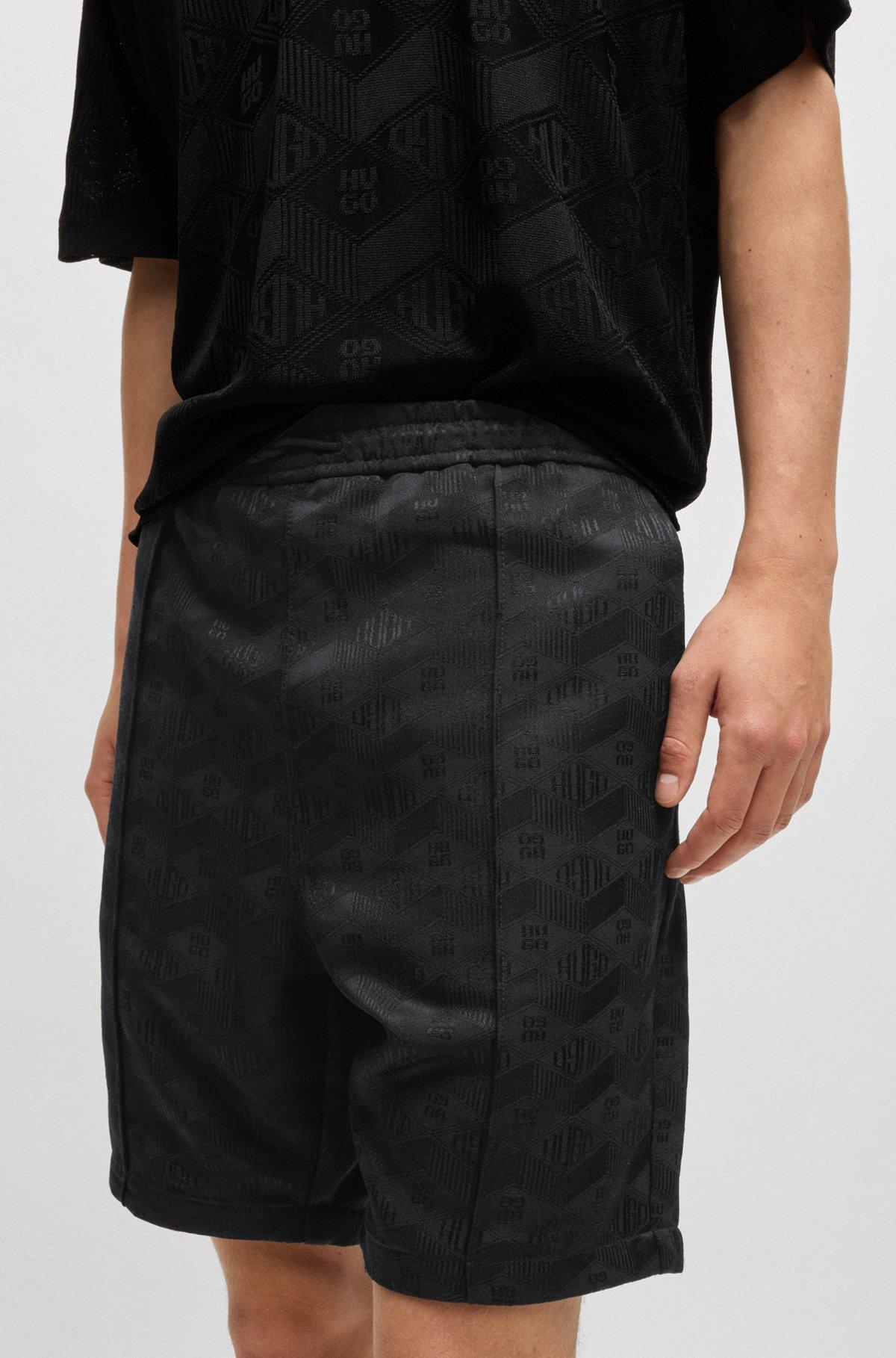 Relaxed-fit shorts with geometric logos Product Image