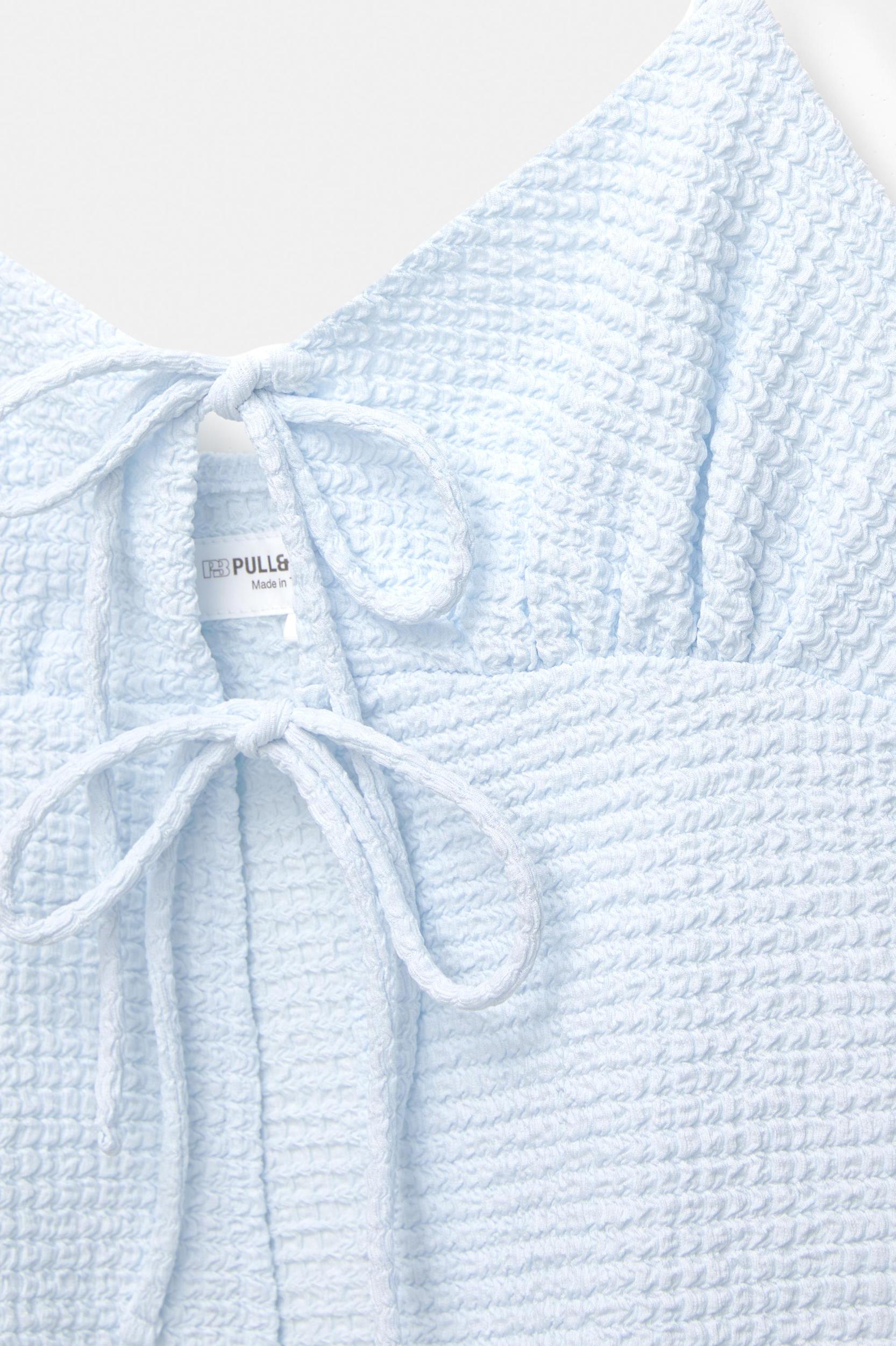 Creased-effect top with bows Product Image