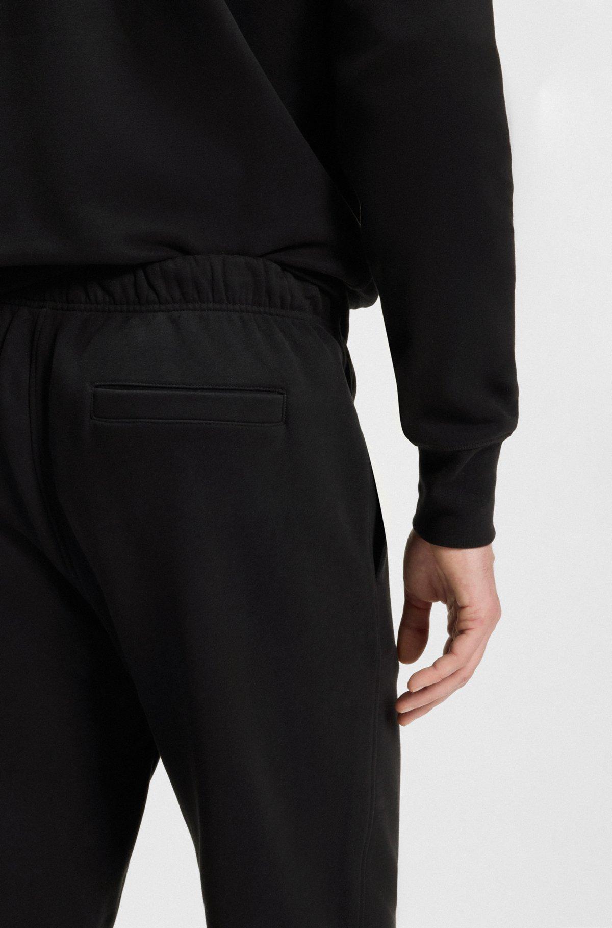 BOSS - BECKHAM x BOSS relaxed tracksuit bottoms in cotton terry - Black Product Image