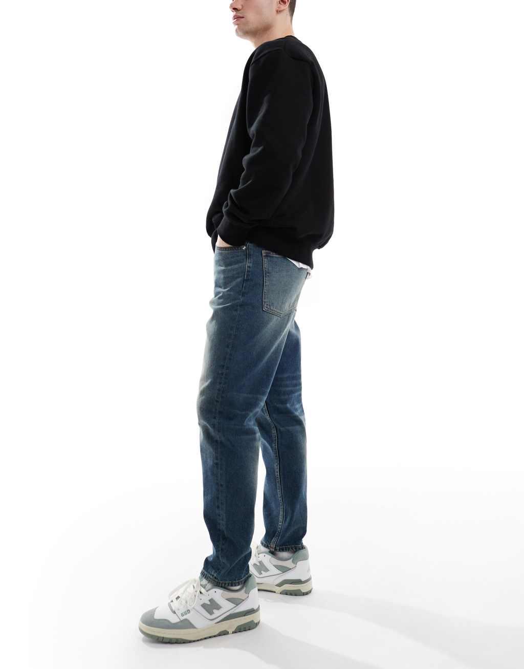 ASOS DESIGN tapered jeans with vintage tint in dark wash blue Product Image