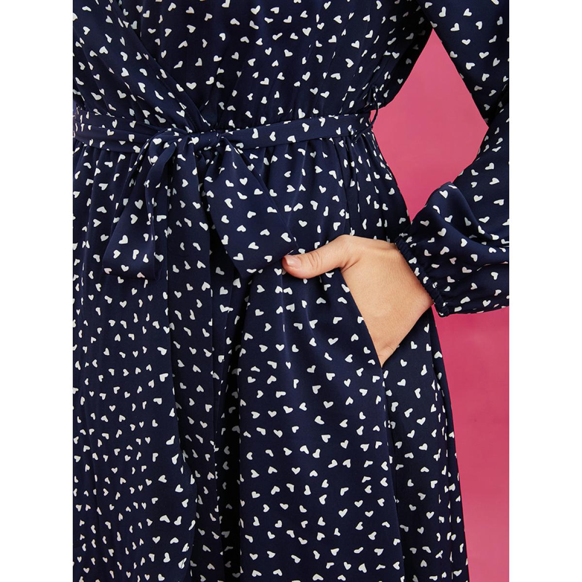 Plus Size Heart Print Surplice Neck Pocket Asymmetrical Belted Flutter Dress Navy Women Elegant Pocket V-neck Long Sleeve Curvy Midi Dress BloomChic 10/M Product Image