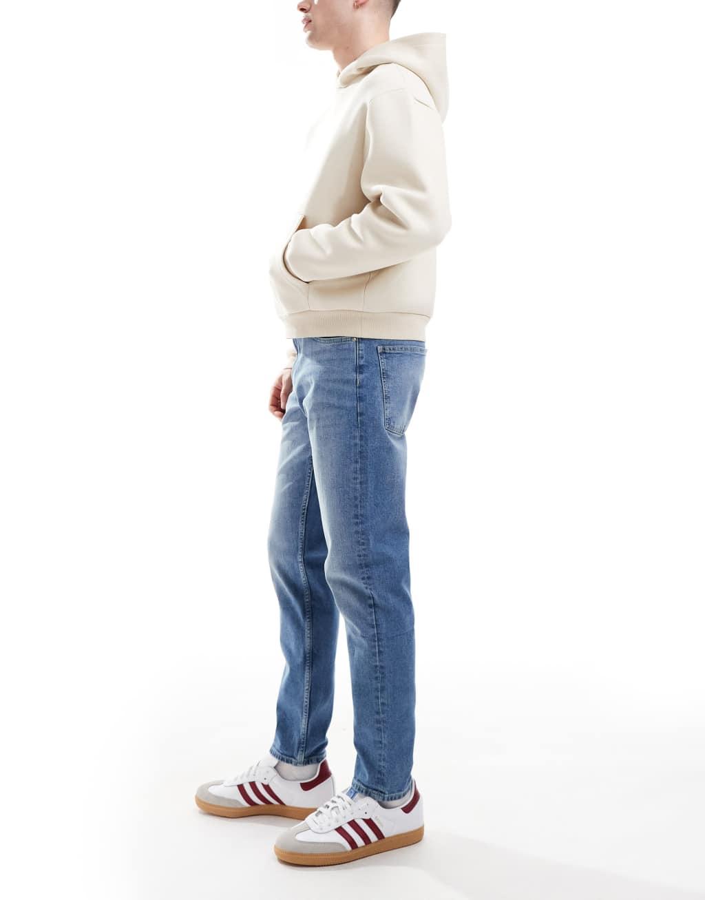 ASOS DESIGN tapered jeans in light wash blue Product Image