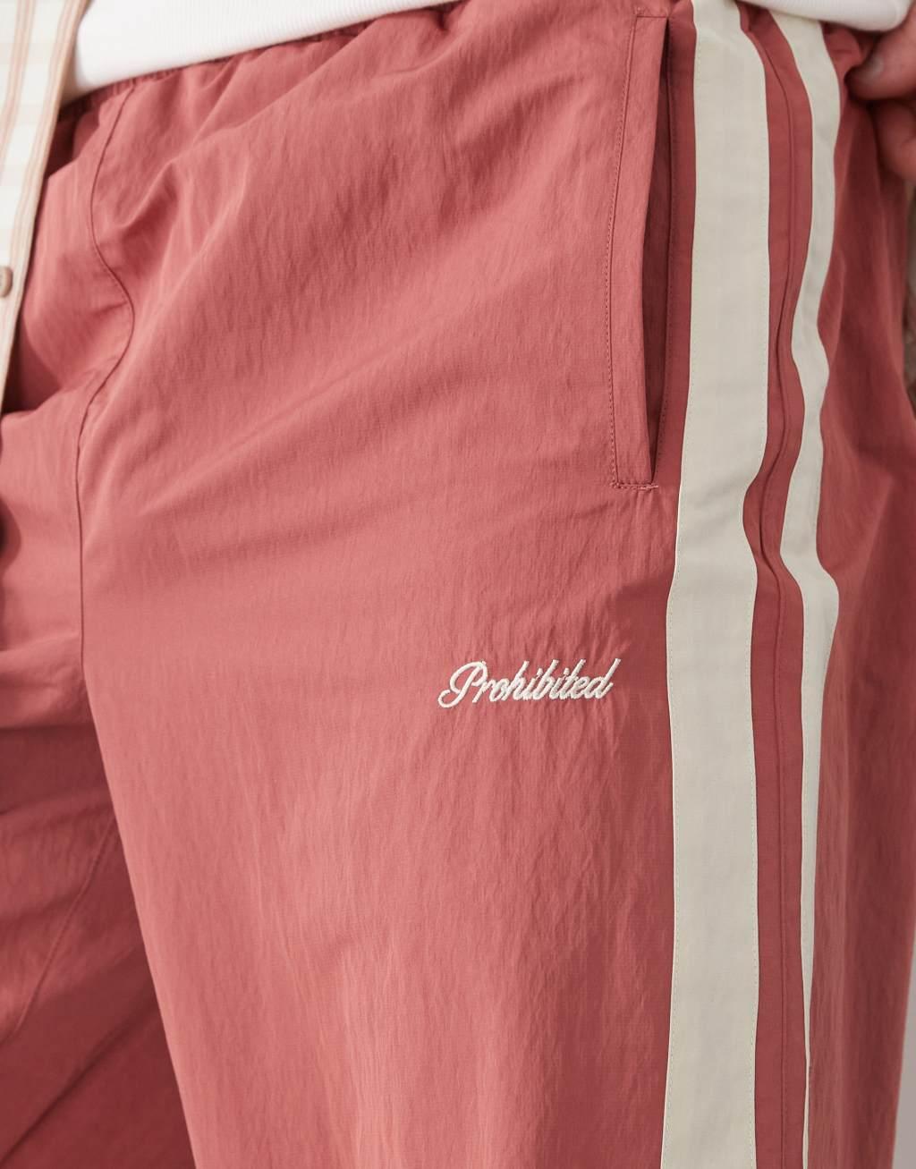 Prohibited stripe track pants in red Product Image