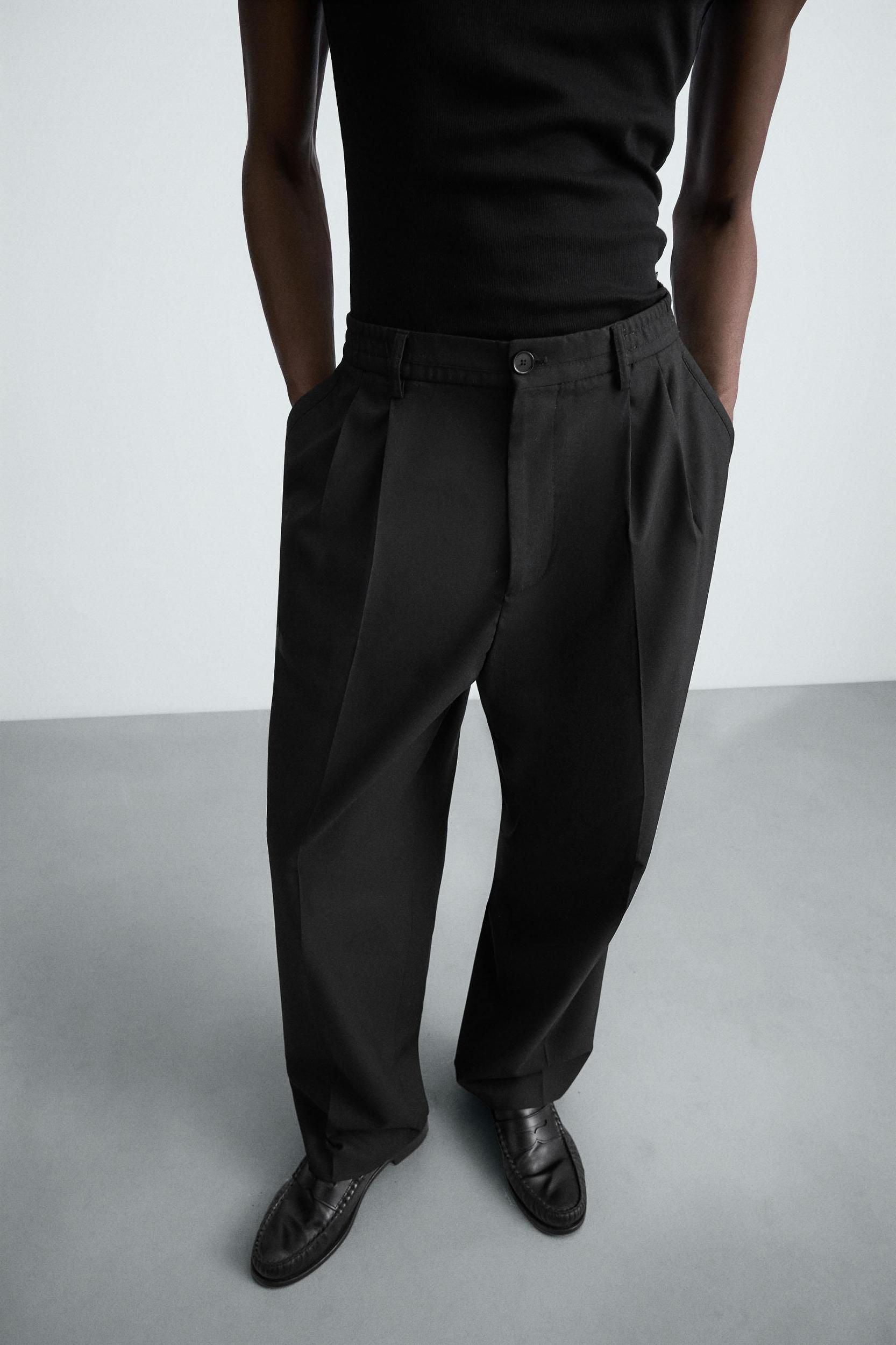 FLOWY PLEATED WIDE FIT PANTS Product Image