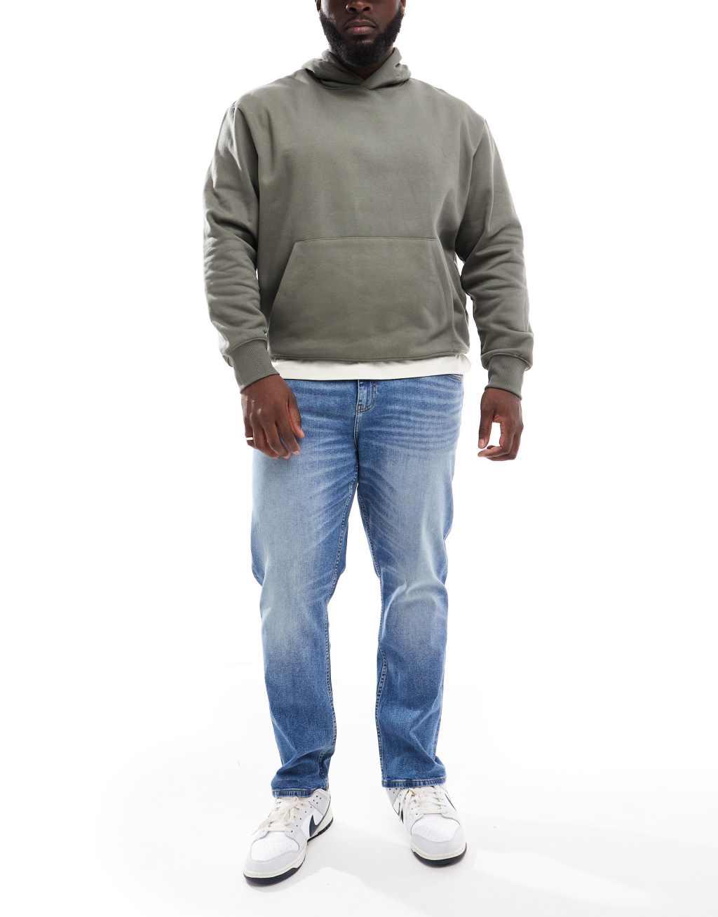 ASOS DESIGN stretch slim jeans in mid wash blue Product Image