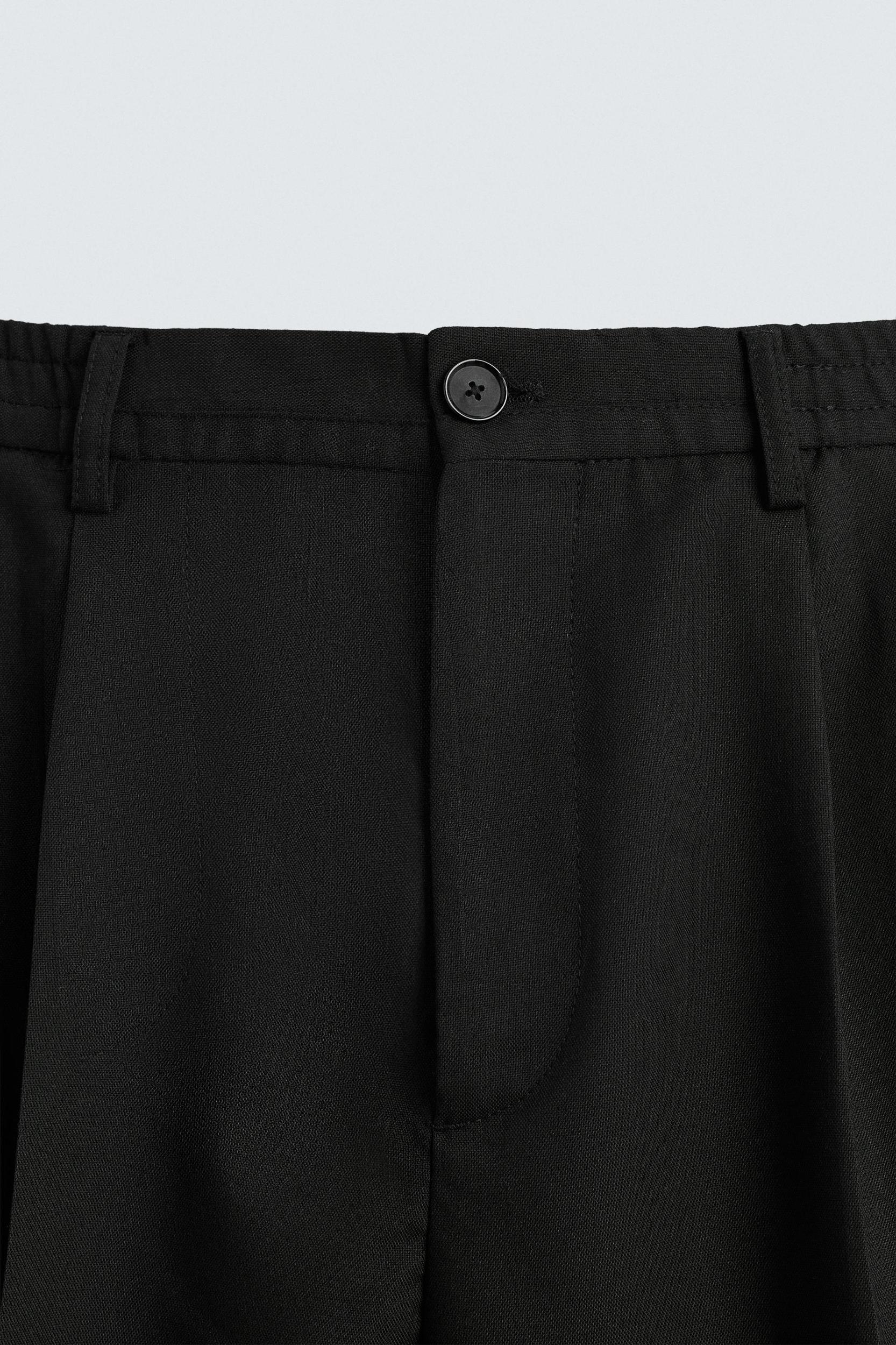 FLOWY PLEATED WIDE FIT PANTS Product Image