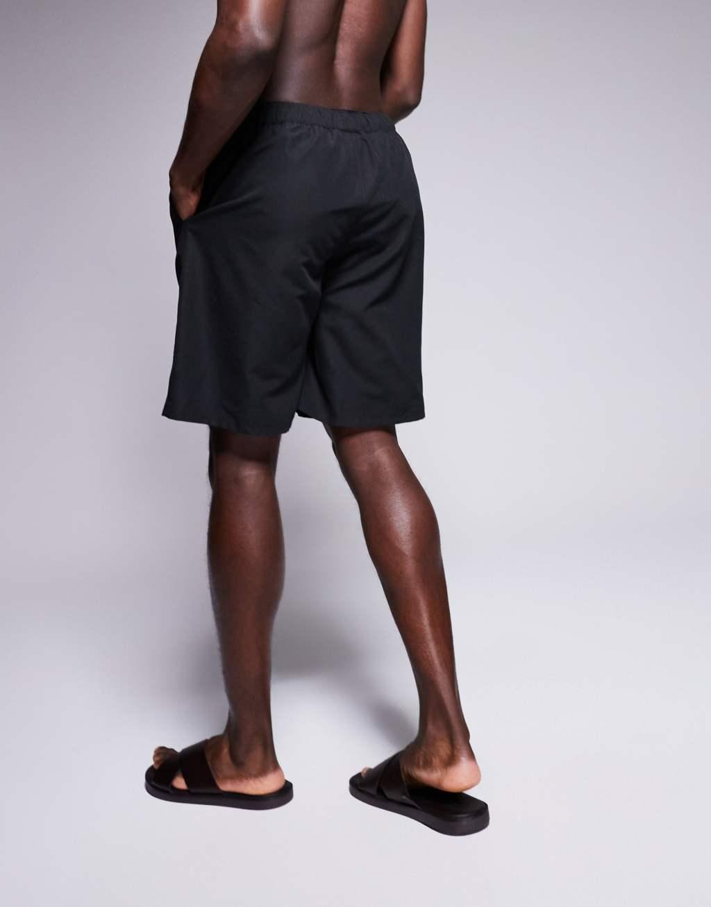 ASOS DESIGN swim shorts in long length in black Product Image