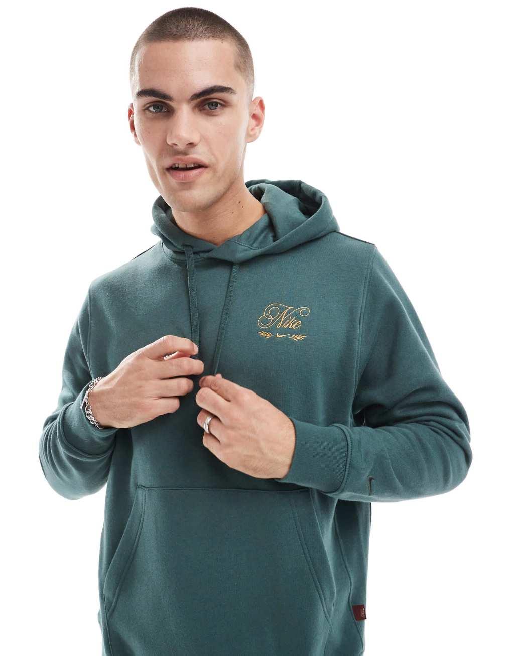 Nike 'Tis The Season logo hoodie in dark green Product Image