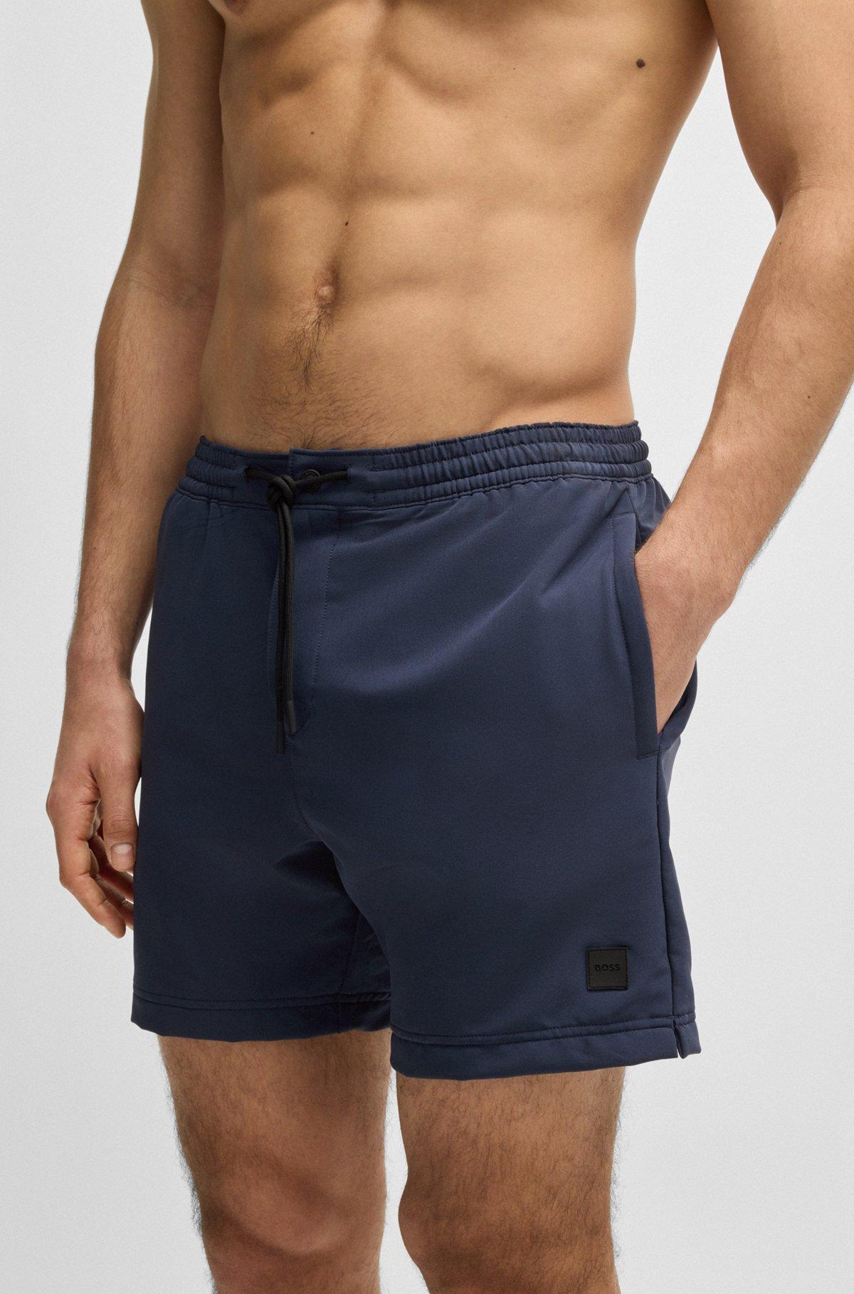 BOSS - Packable swim shorts with logo badge - Dark Blue Product Image