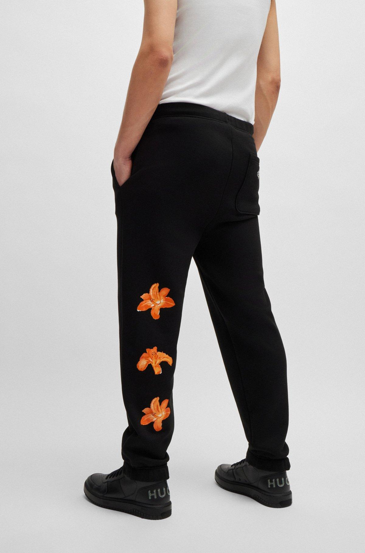 Relaxed-fit tracksuit bottoms with floral logo artwork Product Image