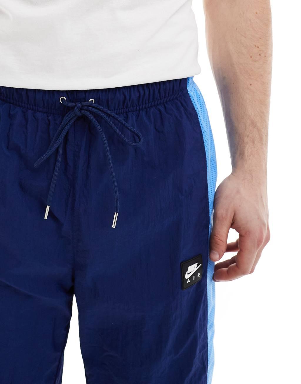 Nike Air woven paneled pants in navy and blue Product Image