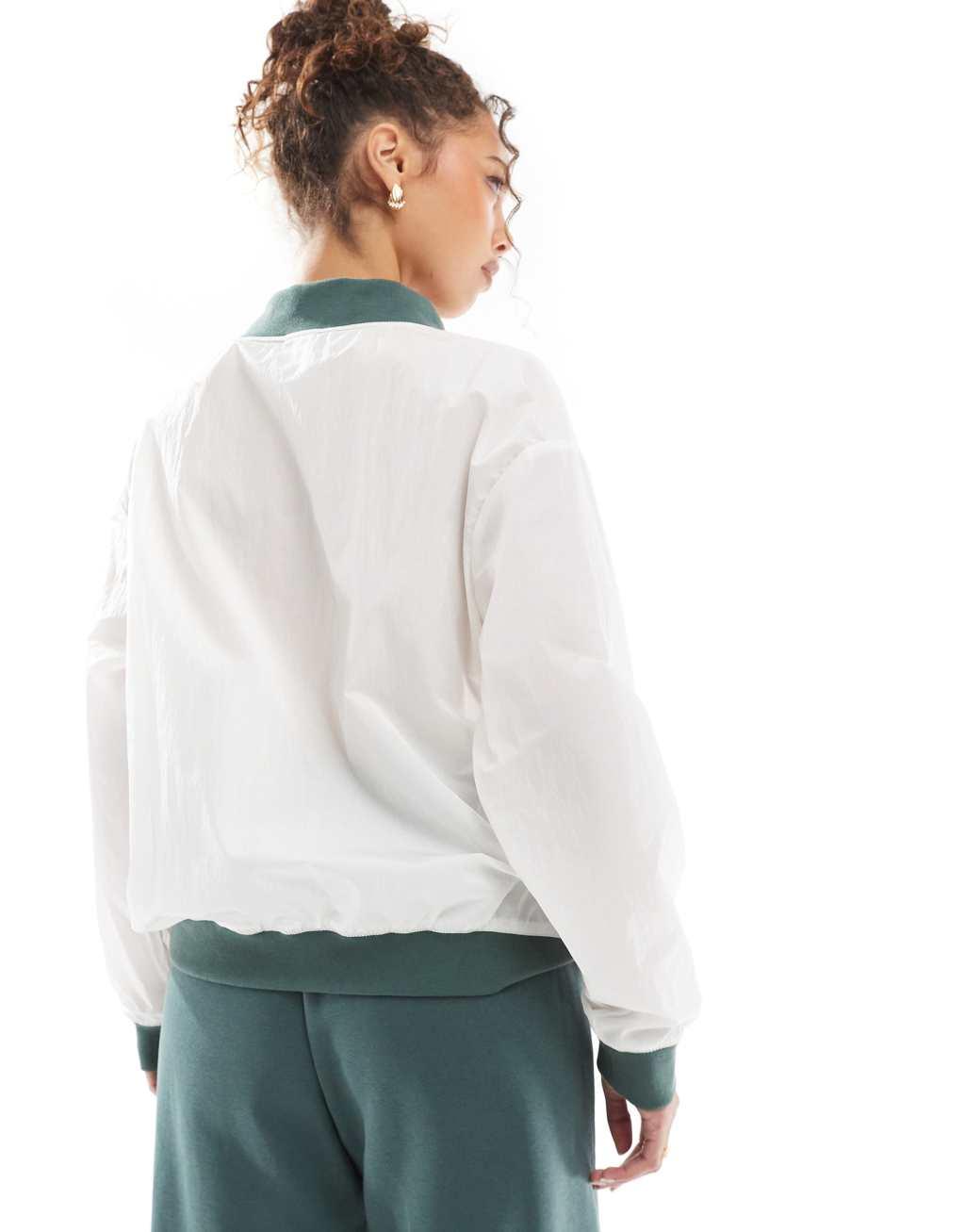 Nike Essential woven v-neck sweatshirt in off white and green Product Image