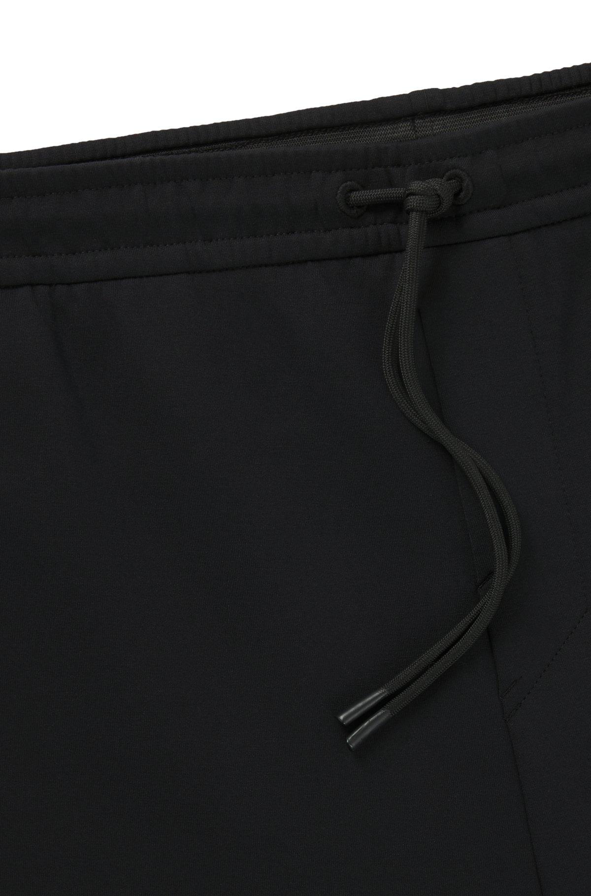 Stretch tracksuit bottoms with logo patch Product Image