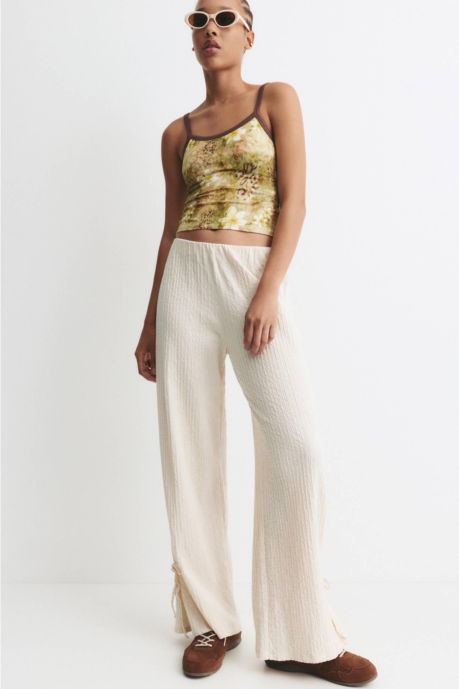 Rustic trousers with knot detail Product Image