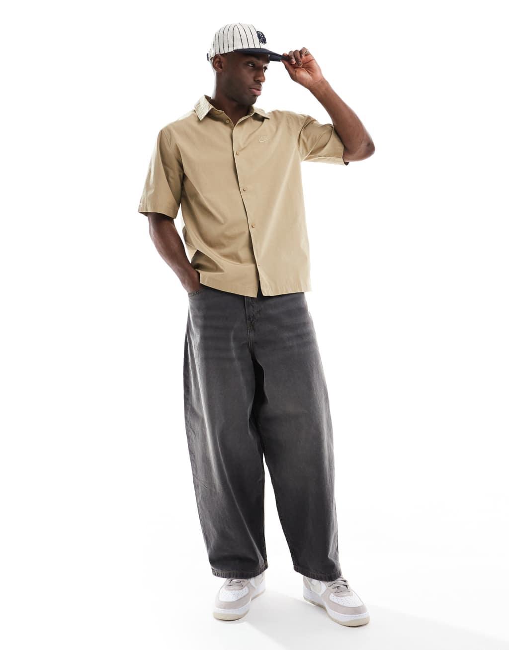 Nike Club short sleeve woven shirt in beige Product Image