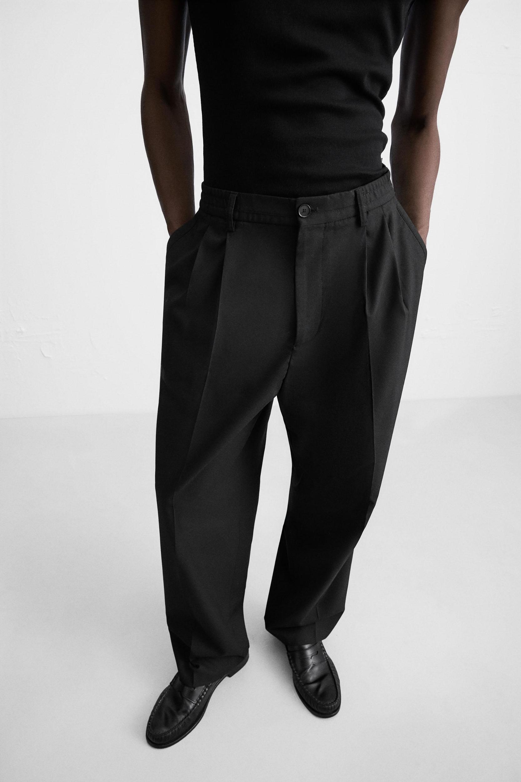FLOWY PLEATED WIDE FIT PANTS Product Image