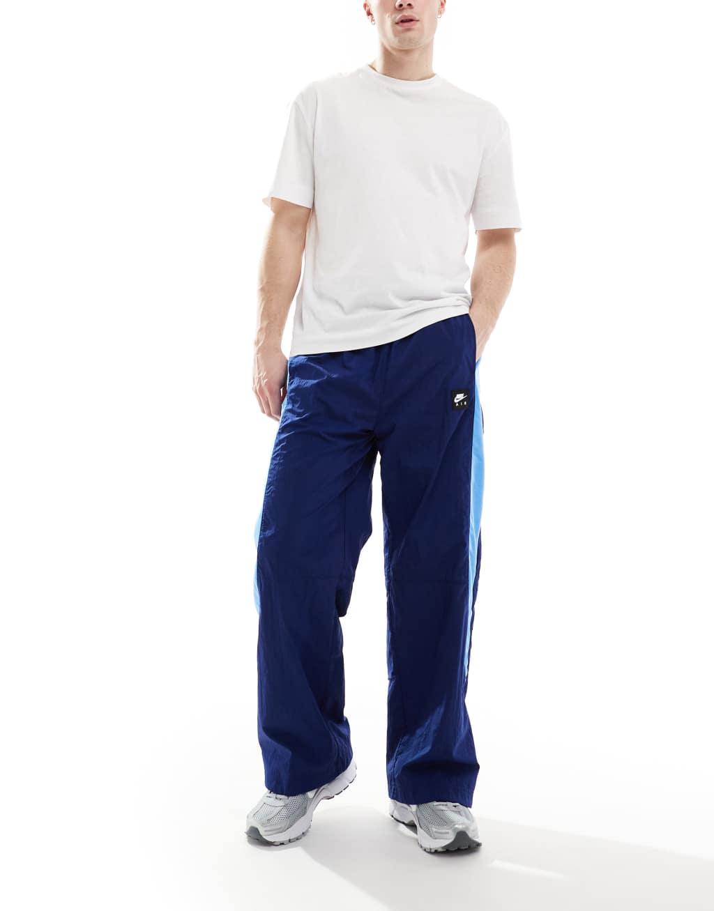 Nike Air woven paneled pants in navy and blue Product Image