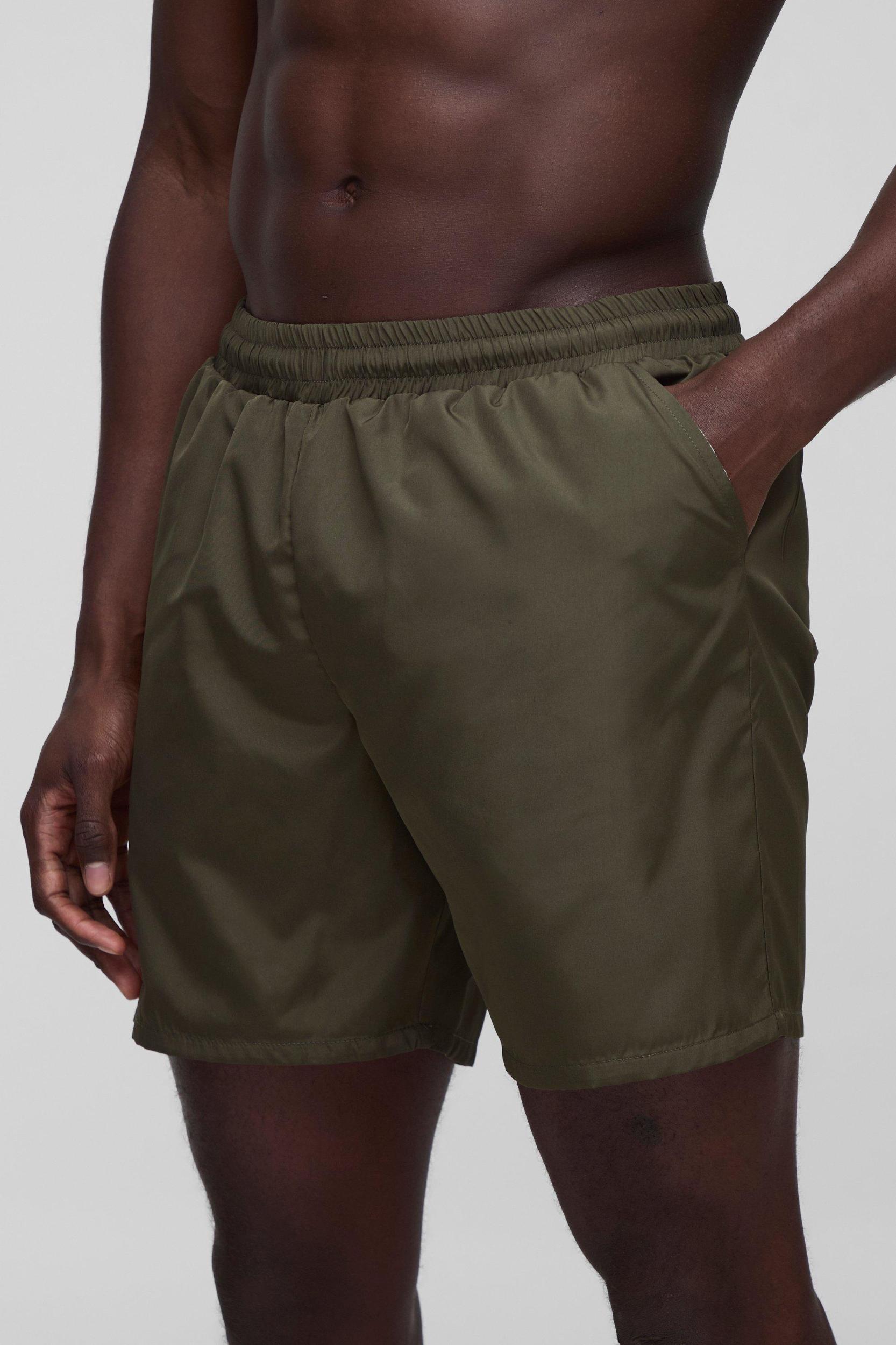 Regular fit Mid length Plain Swim Shorts | boohooMAN USA Product Image