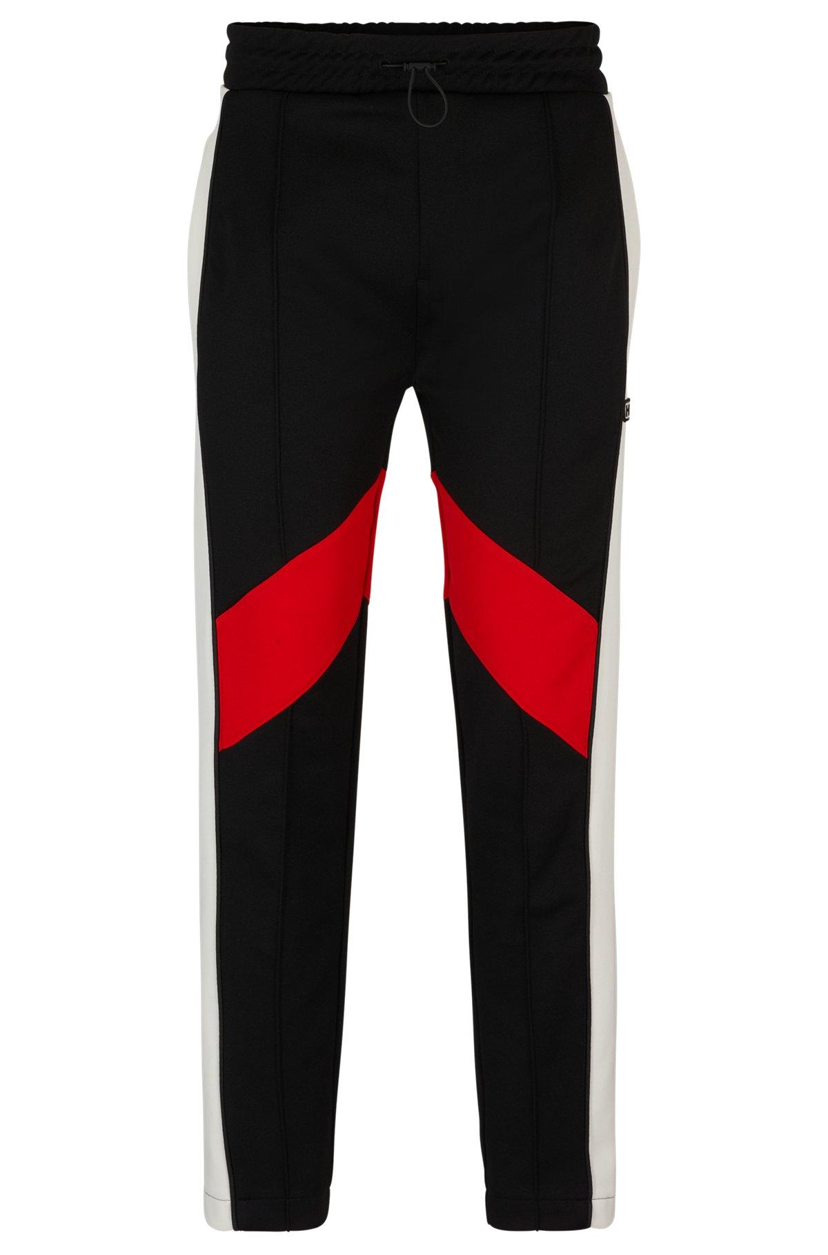 Relaxed-fit tracksuit bottoms with color-blocking Product Image