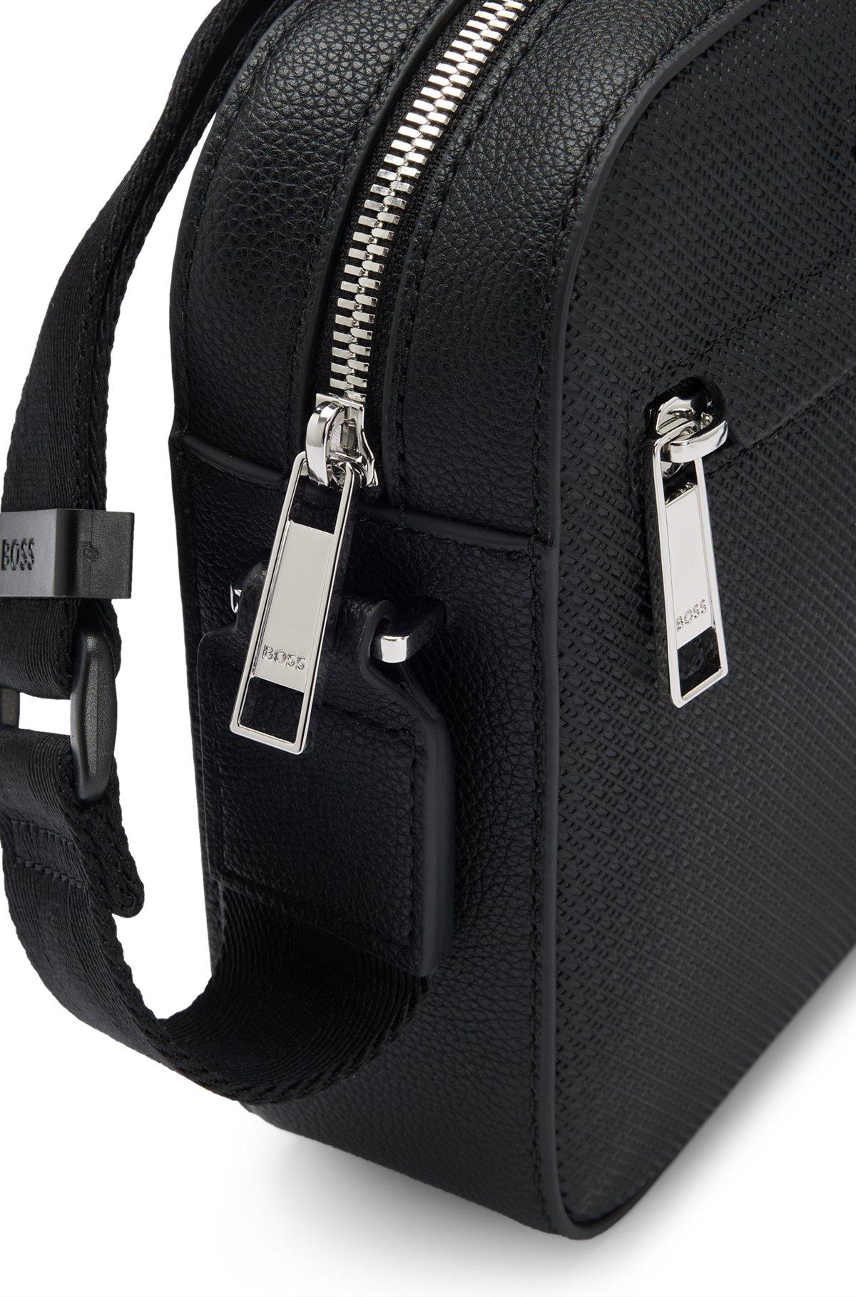 Reporter bag in faux leather with monogram-embossed panels Product Image