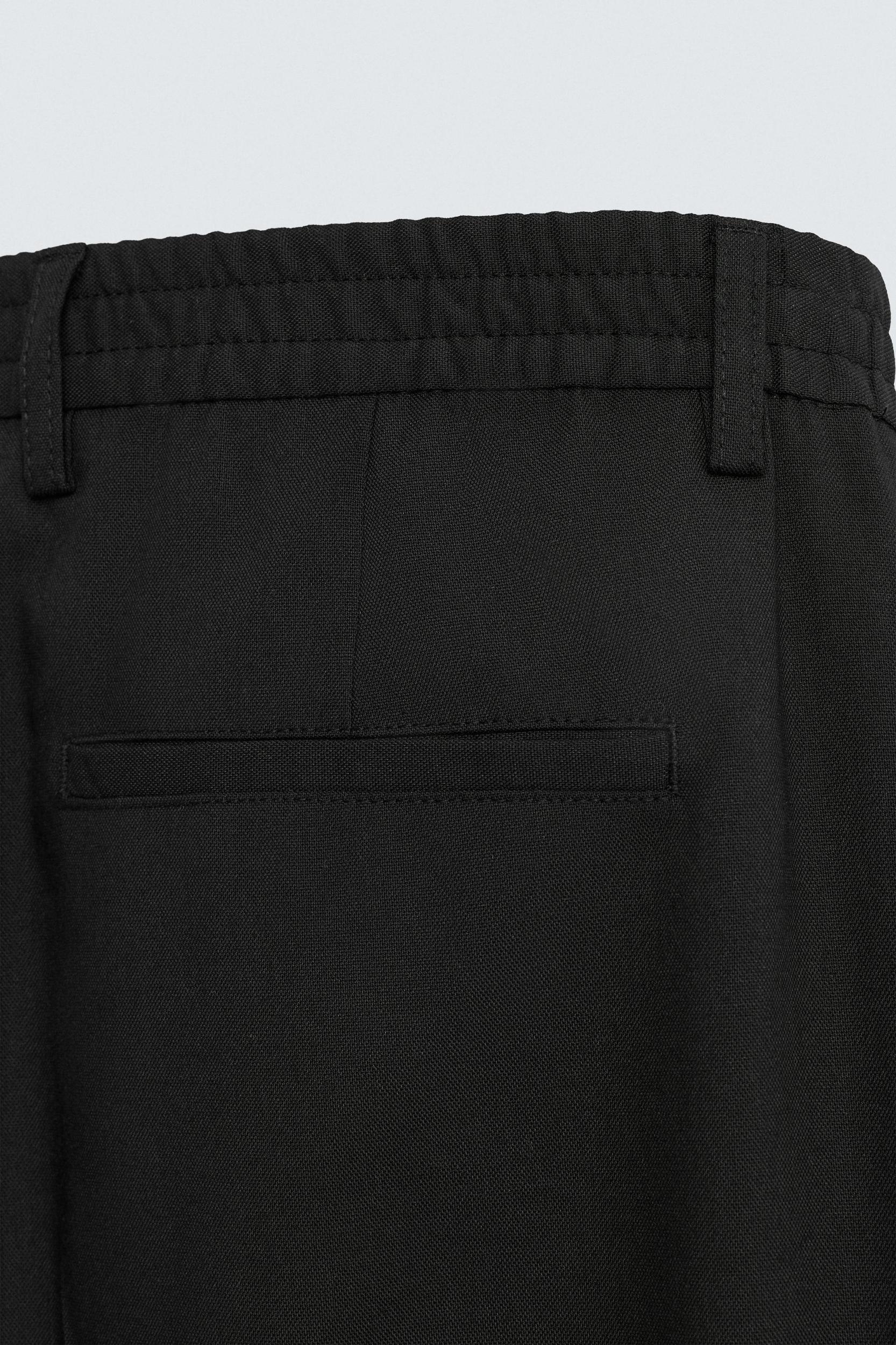 FLOWY PLEATED WIDE FIT PANTS Product Image